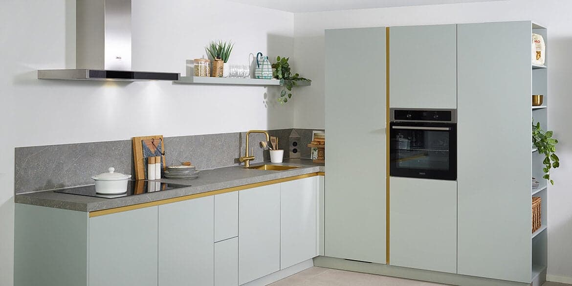 Gouden spoelbak in groene keuken